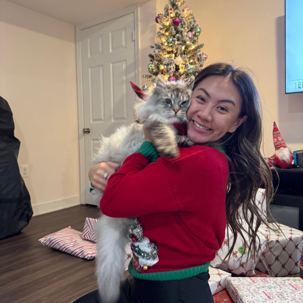 Irena cuddling her fluffy cat during the holidays